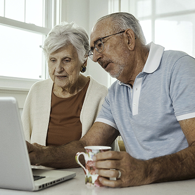 senior couple looking at computer