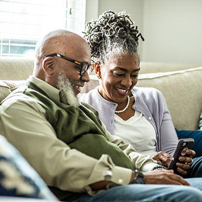 A senior couple talk to someone on a cellphone