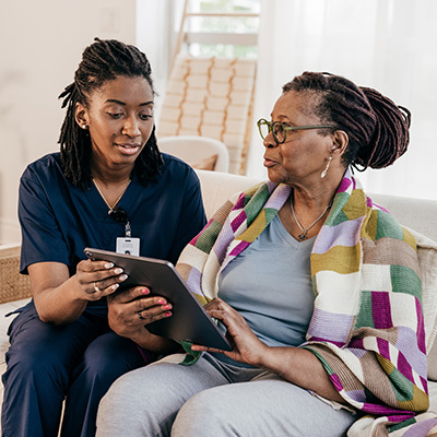 A nurse assists an older woman