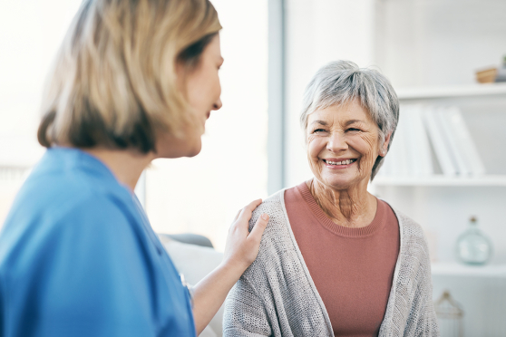A health care worker talks to an elder person